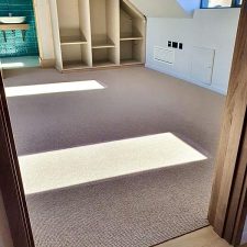 A loft room fitted with a chunky wool loop light brown carpet.