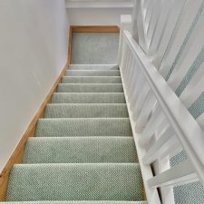 View down stairs fitted with a duck egg coloured zigzag patterned carpet in 80% wool and 20% nylon