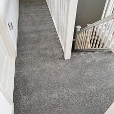 View of a landing and fitted stair carpet in grey Polypropylene pile.