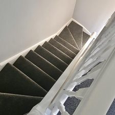 View down stairs fitted with a dark grey polypropylene, bleach cleanable, heavy domestic carpet.