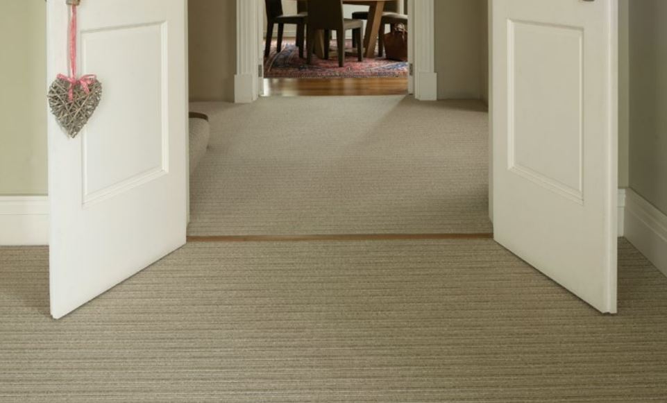 A living room with interconnecting doors open to reveal a striped carpet from the Wellington Stripe collection