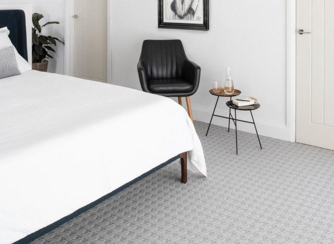 A bedroom carpet with a grey patterned carpet