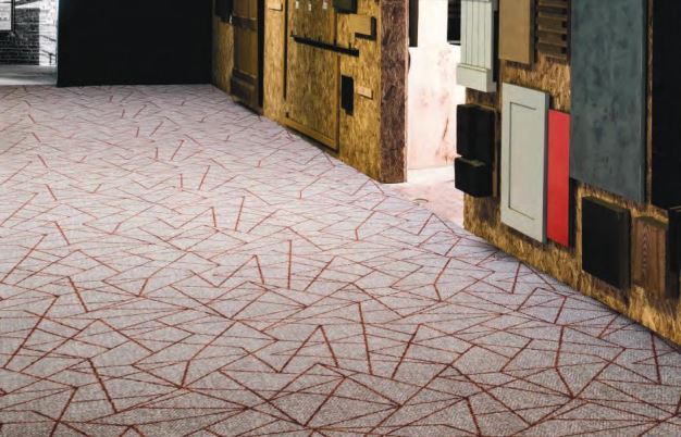A commercial two-tone carpet in grey with a red geometric pattern on