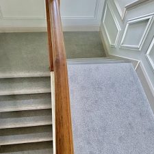 View down stairs fitted with a grey/green wool and nylon twist pile carpet.
