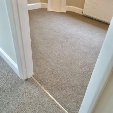 View into a bedroom fitted with a neutral Wool mix berber twist, extra heavy domestic carpet.