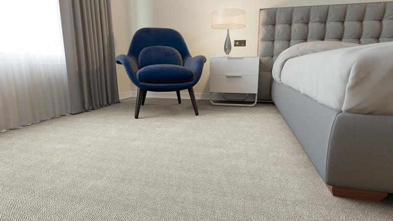 A bedroom with grey decor fitted with a Briar carpet from Westex Carpets.