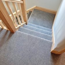 View down stairs which are fitted with a Polypropylene heather twist, bleach cleanable, fade resistant, heavy domestic carpet.