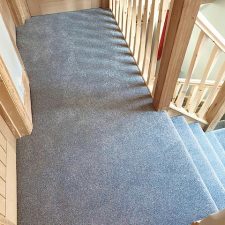 View of a landing which is fitted with a grey fade resistant, heavy domestic carpet.