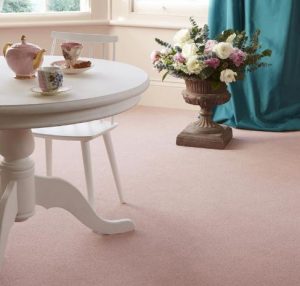 A living room with a pale pink Bell Twist carpet by Brintons.
