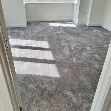 A room with white walls newly carpeted with grey Imprel Finesse polyamide carpet.