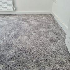 A room with white walls newly carpeted with grey Imprel Finesse polyamide carpet.