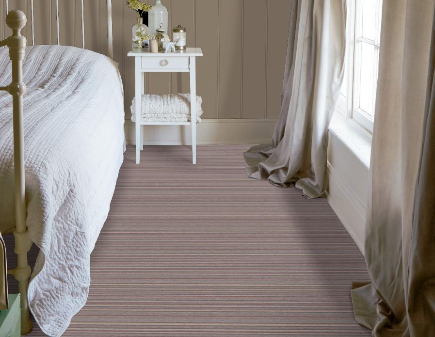 Bedroom with neutral walls and soft furnishings and pale striped carpet