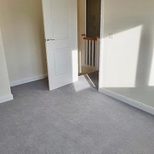View of bedroom floor fitted with grey heavy domestic wool twist carpet