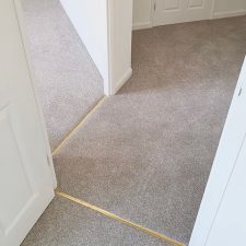 Thresholds between hallway and two rooms fitted with Polypropylene twist pile, bleach cleanable, fade resistant, moth proof carpet