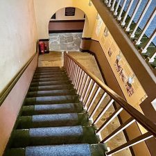 View down a flight of stairs in a period property fitted with a stair runner made from 80% cashmere goat hair. natural cord carpet