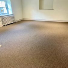 Living room fitted with a synthetic sisal propylene pile carpet which is bleach cleanable, fade resistant and moth proof.