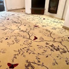 Living room fitted with a beige wool woven Axminster carpet with butterfly and tree design