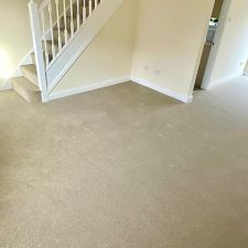 View of an open plan front room fitted with a light brown polypropylene twist pile carpet