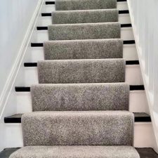 View up a flight of stairs with grey polypropylene twist, 2 ply yarn, moth resistant, fade resistant, bleach cleanable, heavy domestic quality carpet.