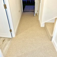 Hallway fitted with a beige wool loop carpet with 2 ply yarn