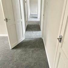 A hallway fitted with a grey polypropylene twist pile carpet which is fade resistant and moth resistant