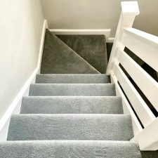 A flight of stairs fitted with a grey polypropylene twist pile carpet