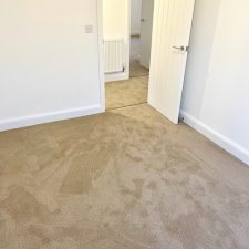 Bedroom fitted with a polypropylene twist heavy duty domestic carpet in a beige colour, which is moth resistant and bleach cleanable .