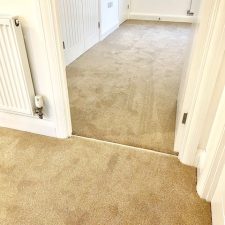View of a landing and bedroom fitted with a polypropylene twist heavy duty domestic carpet in a beige colour, from the Primo Ultra range by Cormar Carpets