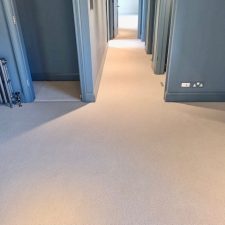 A dressing room with a beige luxury wool loop heavy domestic carpet