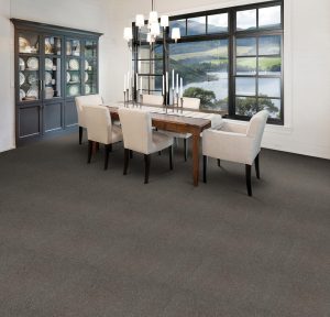 Formal dining room with display cabinet, views over a lake and deep brown carpet from the Cumbrian range by Penthouse Carpets.