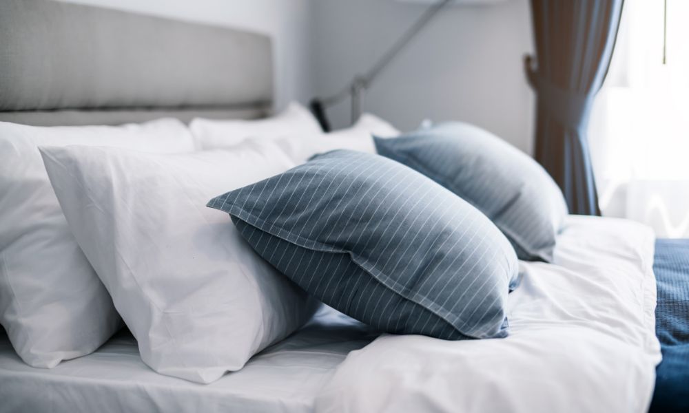 Closeup of pillows and bedding on a bed in a bedroom.