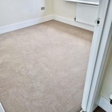 View of a bedroom fitted with an 80% wool, 20% synthetic mixture twist pile carpet.