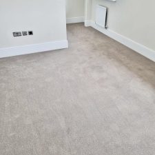 View of a bedroom fitted with an 80% wool, 20% synthetic mixture twist pile carpet.