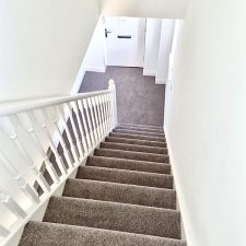 View down a flight of stairs fitted with an 80% wool, 20% synthetic mixture twist carpet