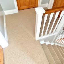 View of a landing fitted with a beige wool loop pile carpet.