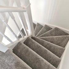 View down a flight of stairs in a new build fitted with a mid grey polypropylene twist, bleach cleanable, fade resistant and moth proof carpet.