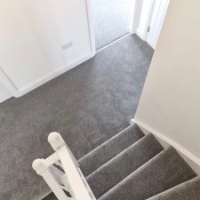 View of stairs and landing in a new build fitted with a mid grey polypropylene twist, bleach cleanable, fade resistant and moth proof carpet.