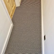 View of a hallway fitted with a two-tone striped wool carpet.