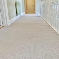 View of a large landing fitted with a pale wool carpet over new underlay.