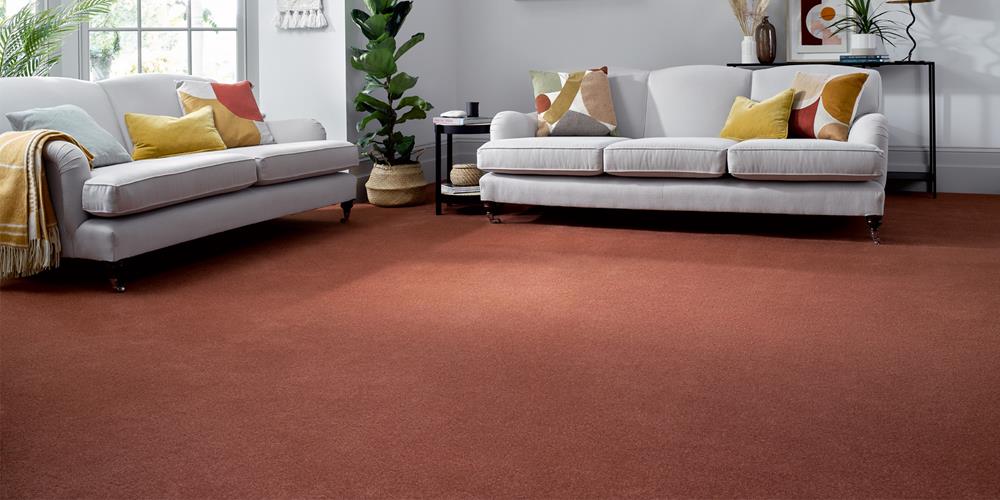 A living room with rust coloured wool loop carpet.
