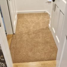 View of a small landing fitted with a coffee coloured woven Wilton carpet.