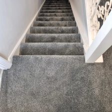 View down a flight of stairs fitted with a grey 100% polypropylene Saxony carpet which was fitted to a refurbished house in Barnham.