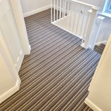 View of a landing fitted with a 100% wool heavy domestic brown striped carpet