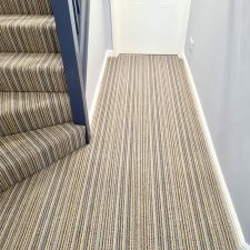 View of a downstairs hall fitted with a striped beige/brown high and low level wool loop carpet.