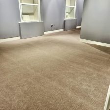 An exhibition room fitted with a high quality woven beige coloured carpet.