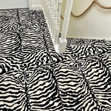 View of a landing fitted with a black and white zebra wool and nylon Axminster carpet.