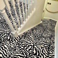 View down stairs fitted with a black and white zebra moth proof Axminster wool carpet.