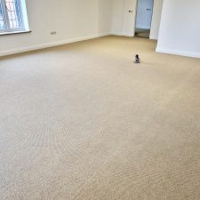 View of a large living room fitted with beige wool loop, moth proof carpet in a renovated house in Itchenor.
